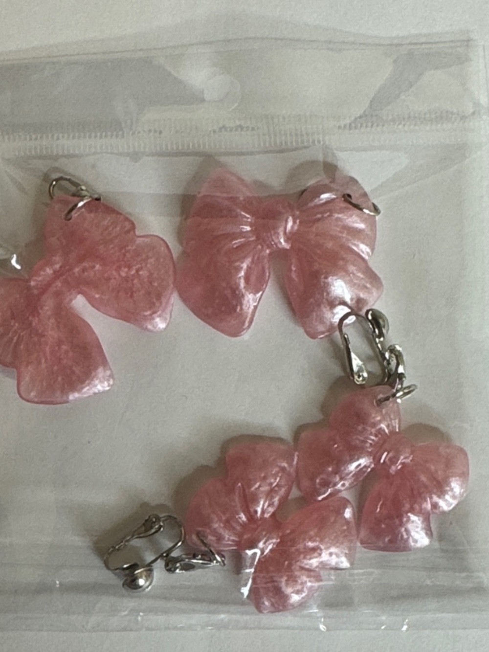 Pink Resin Bow Clip-On Earrings — Feminine Hair Accessory